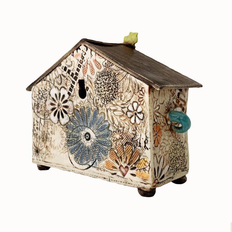 Handmade porcelain house by ceramic artist Barbara Chadwick, flowers with leaf detail on top. Back view.