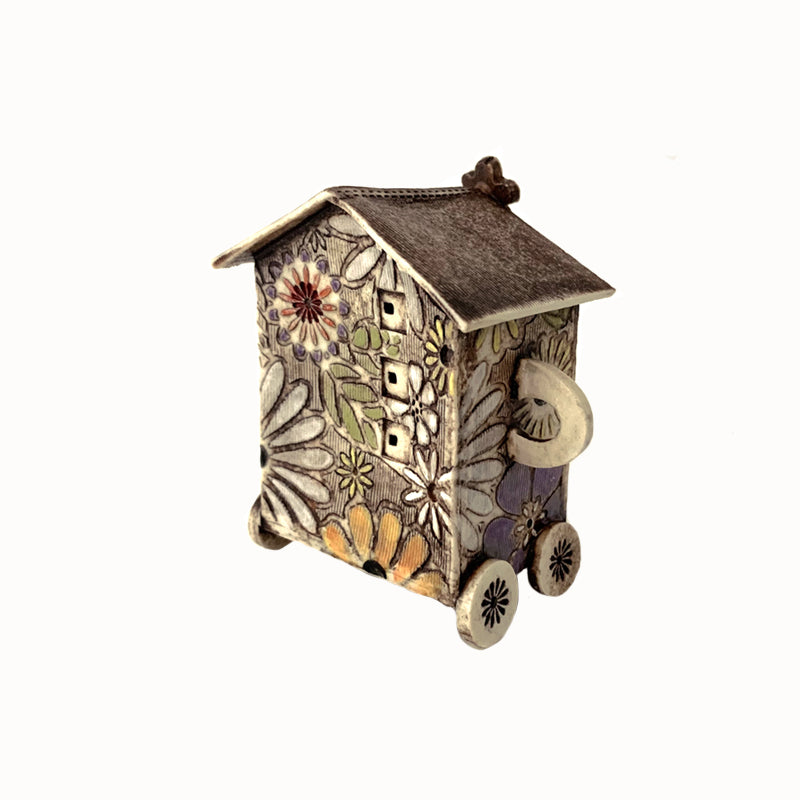 Handmade porcelain house by ceramic artist Barbara Chadwick, small with white, orange and purple flowers.