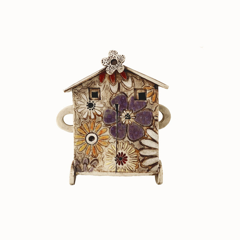 Handmade porcelain house by ceramic artist Barbara Chadwick, small with white, orange and purple flowers.