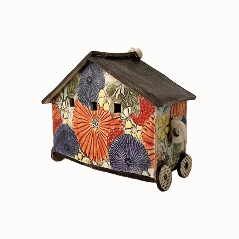Handmade porcelain house by ceramic artist Barbara Chadwick, colorful flower pattern with heart detail on top. Back view.