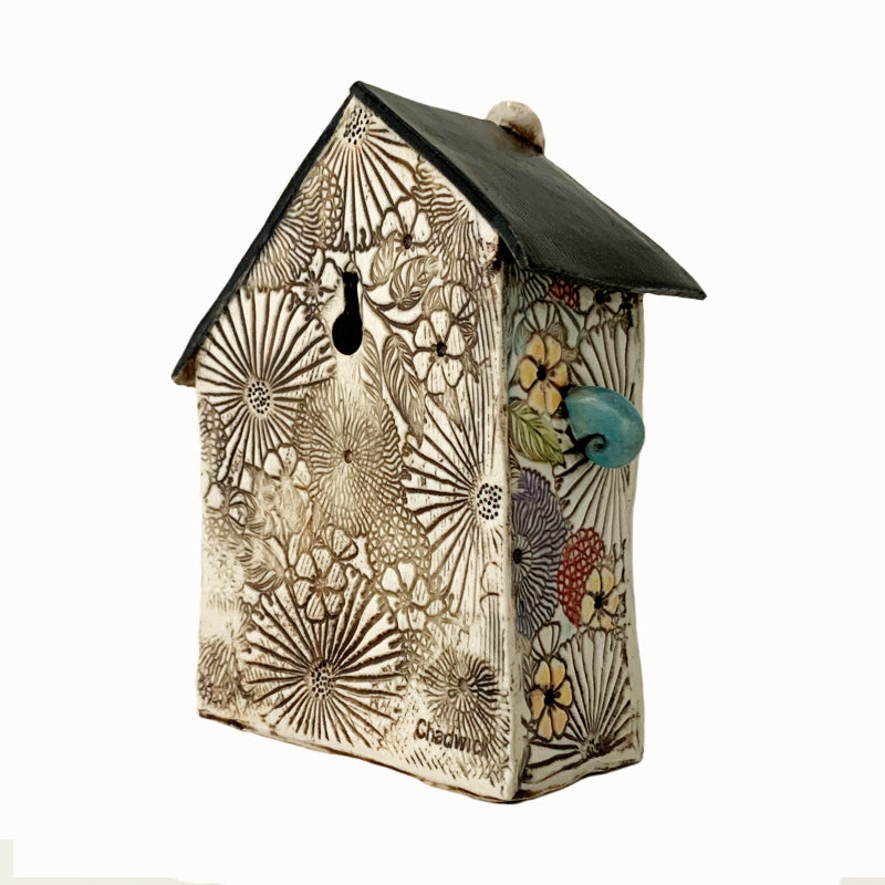 Handmade porcelain house by ceramic artist Barbara Chadwick, flower and insect details. Back view.