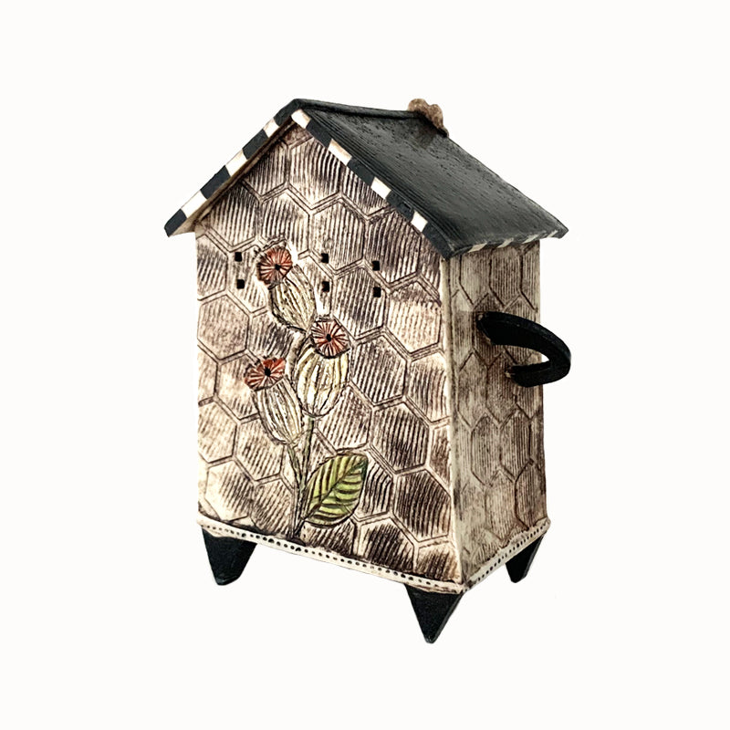 Handmade porcelain house by ceramic artist Barbara Chadwick, honeycomb and bee design. Back view.