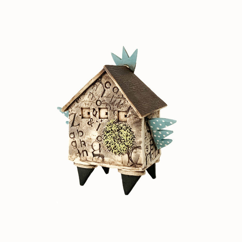 Handmade porcelain house by ceramic artist Barbara Chadwick. Textured with polka dot wings. Back view.