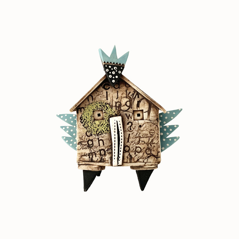 Handmade porcelain house by ceramic artist Barbara Chadwick. Textured with polka dot wings.