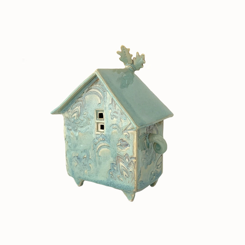 Handmade porcelain house by ceramic artist Barbara Chadwick, small seafoam green house with botanical details. Back view.