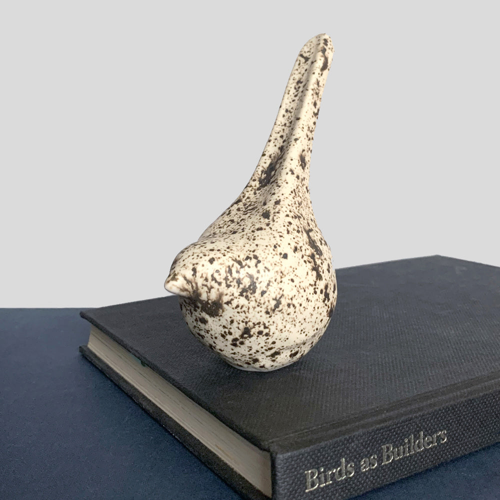 Small hand sculpted ceramic bird, cream with dark speckled pattern, by Beck Story.