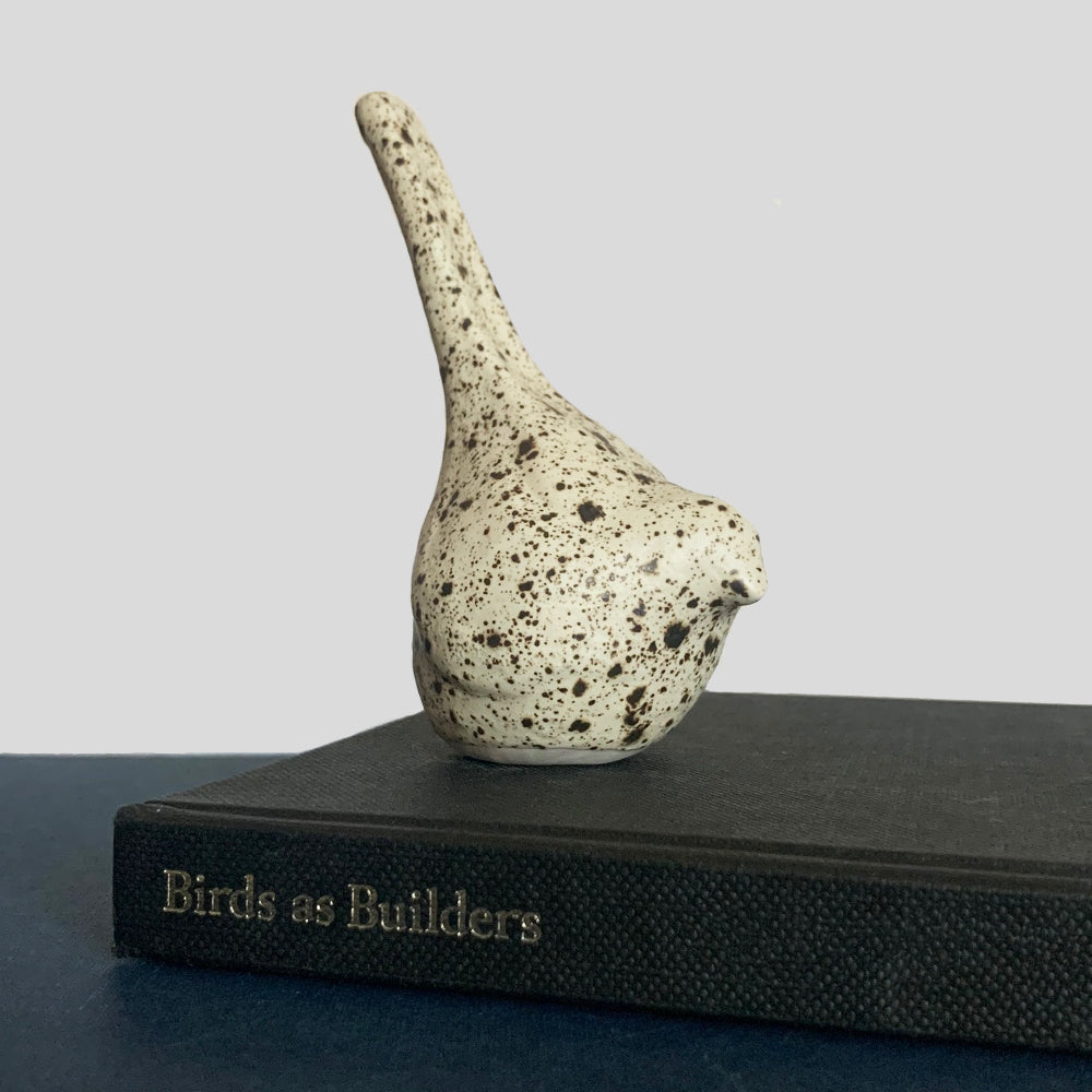 Small hand sculpted ceramic bird, cream with dark speckled pattern, by Beck Story.
