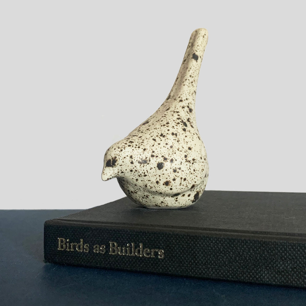 Small hand sculpted ceramic bird, cream with dark speckled pattern, by Beck Story.