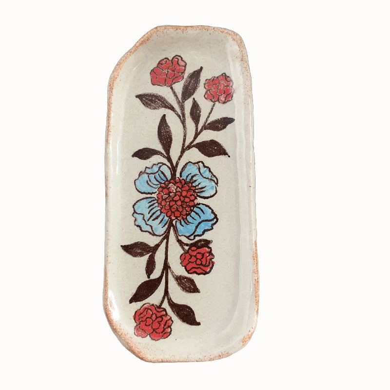 Handmade pottery from Off Menu Pots. Small dish with blue and red flowers.