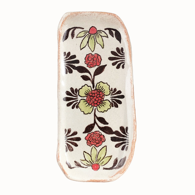 Handmade pottery from Off Menu Pots. Small dish decorated with red and chartreuse flowers.