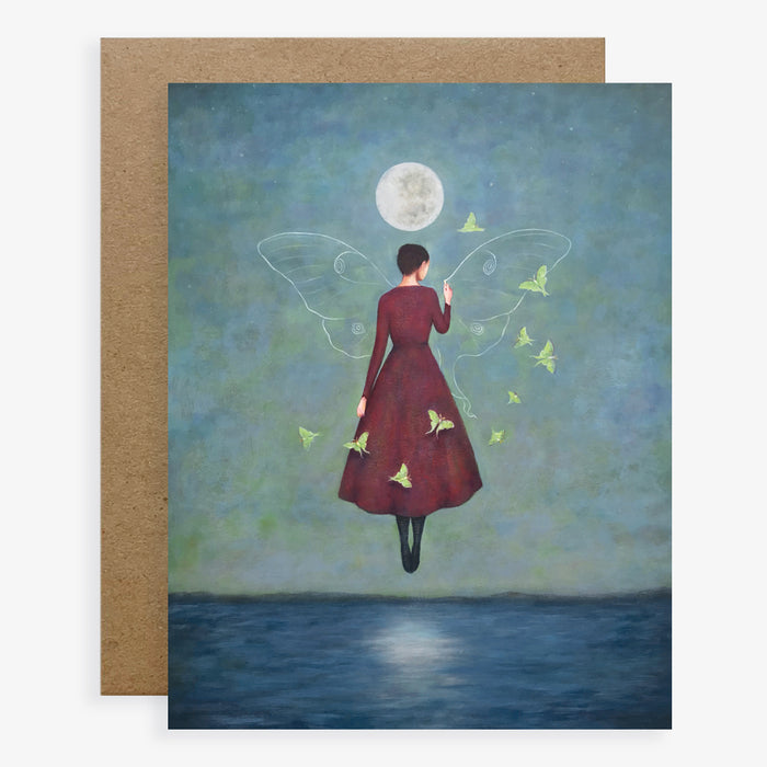 Duy Huynh notecard "Drawn Together". A woman levitates above the ocean drawing the wings of a luna month under a full moon. Luna moths surround her. Card is blank inside.
