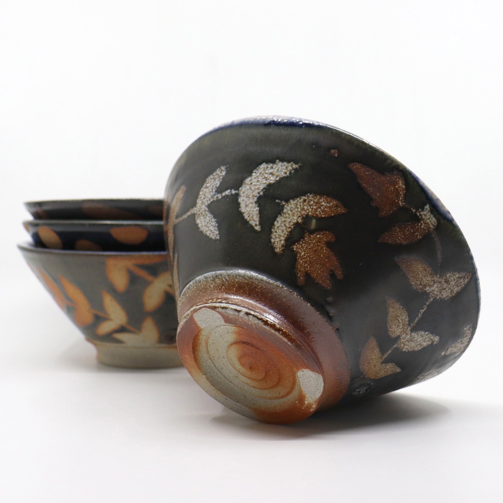 Heather Ossandon handmade, wood-fired ceramics. Cereal bowl, black and blue with rust and cream botanical pattern. Alternate view.