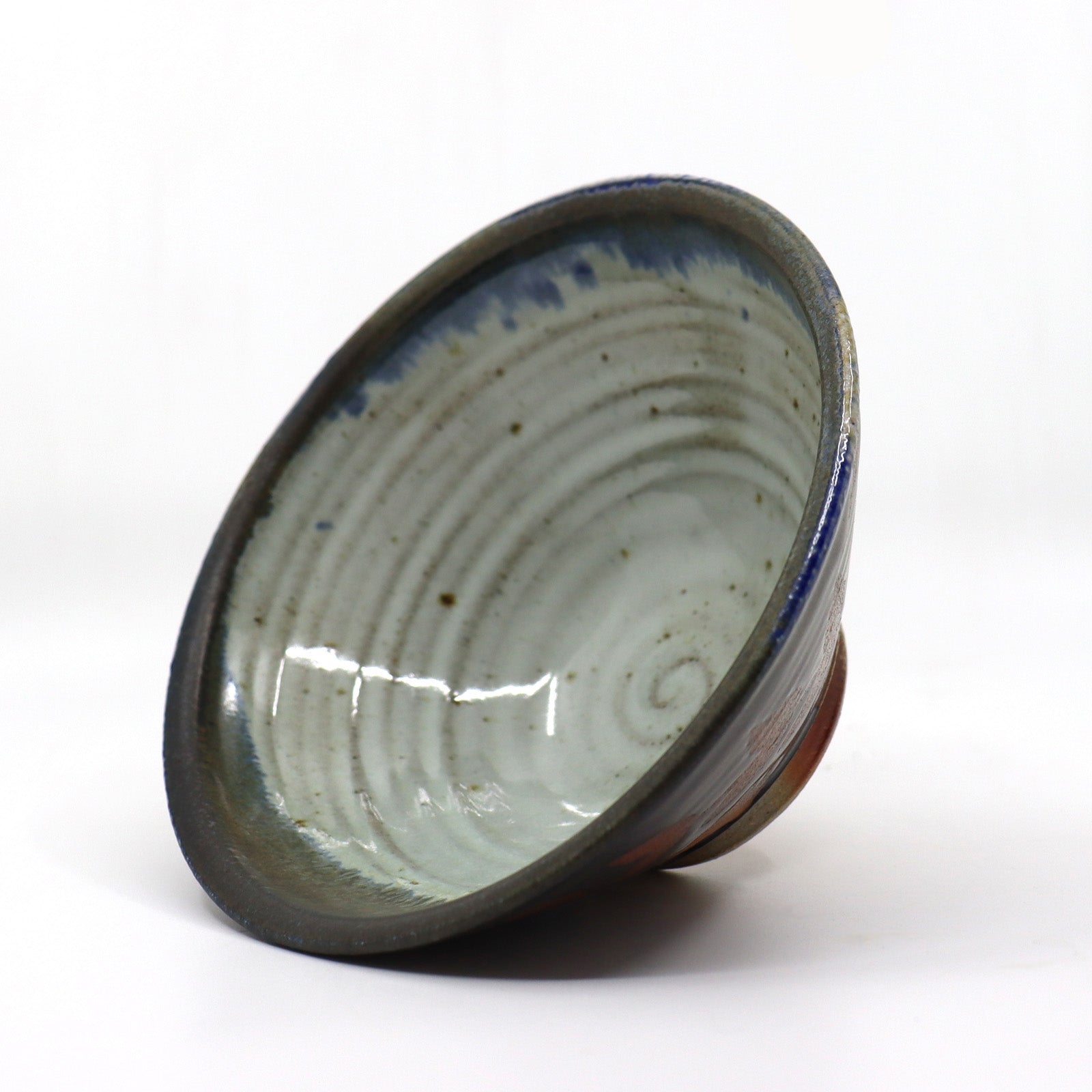 Heather Ossandon handmade, wood-fired ceramics. Cereal bowl, black and blue with rust and cream botanical pattern. Interior view.