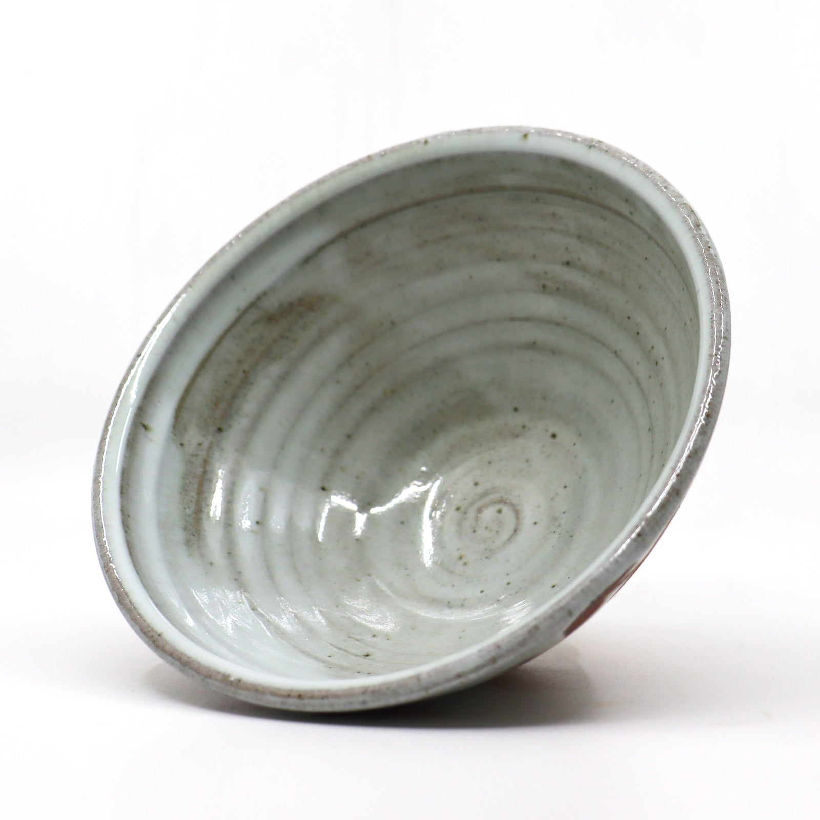 Heather Ossandon handmade, wood-fired ceramics. Cereal bowl, black  with rust flower pattern. Interior view.