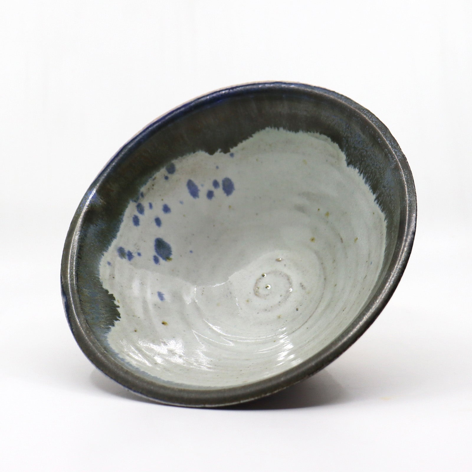 Heather Ossandon handmade, wood-fired ceramics. Cereal bowl, black  with rust flower pattern. Interior view.