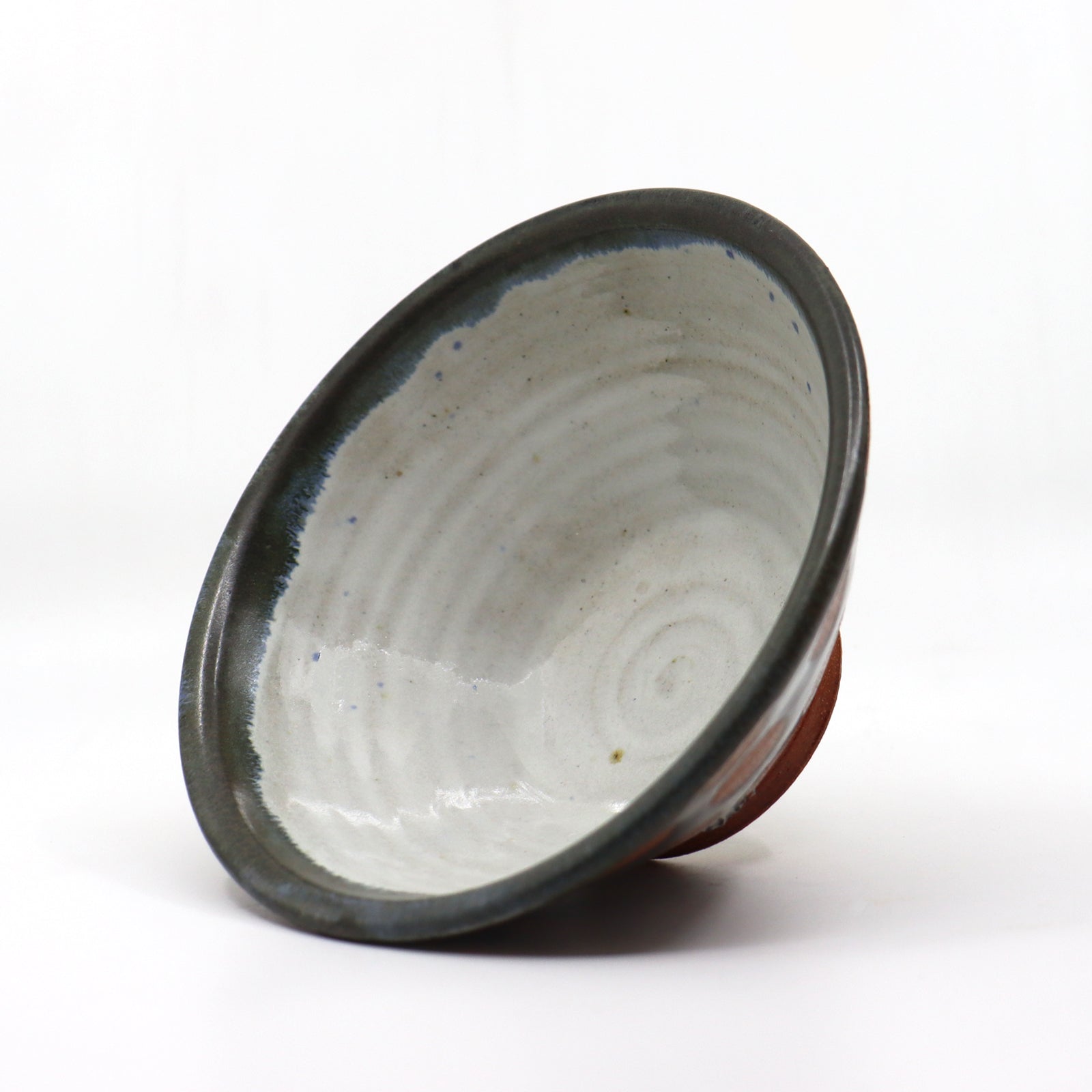 Heather Ossandon handmade, wood-fired cereal bowl. Black with rust polka dots. Interior view.