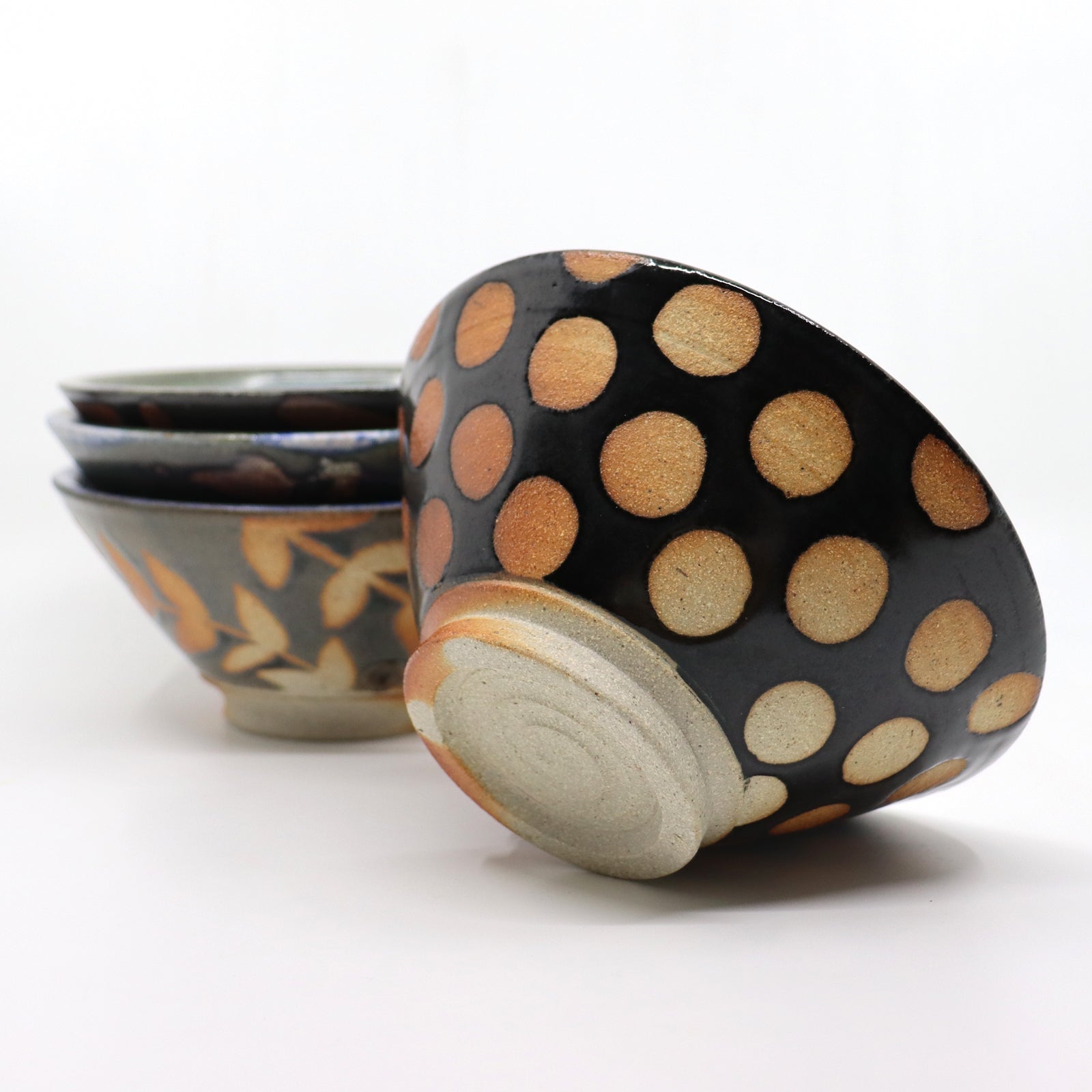 Heather Ossandon handmade, wood-fired cereal bowl. Black with rust polka dots. Alternative view.