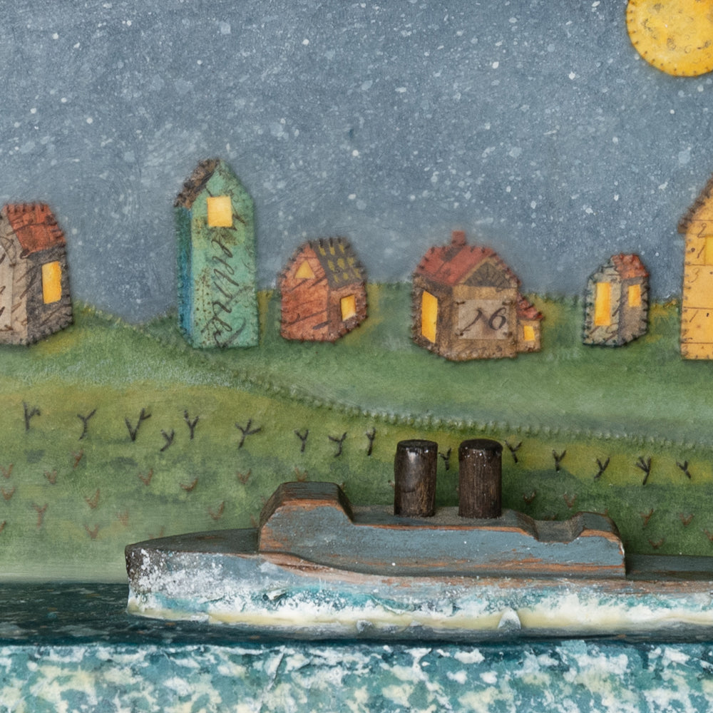 Detail of "By the Stars" mixed media encaustic assemblage by Janet Eskridge. A row of houses under a star filled sky, with a wooden boat in the water.