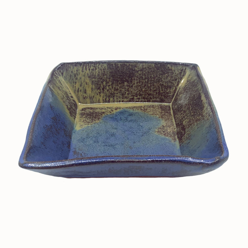 Small, multicolor square bowl by potter Jim Rientjes. Earthy tones and vibrant blues.