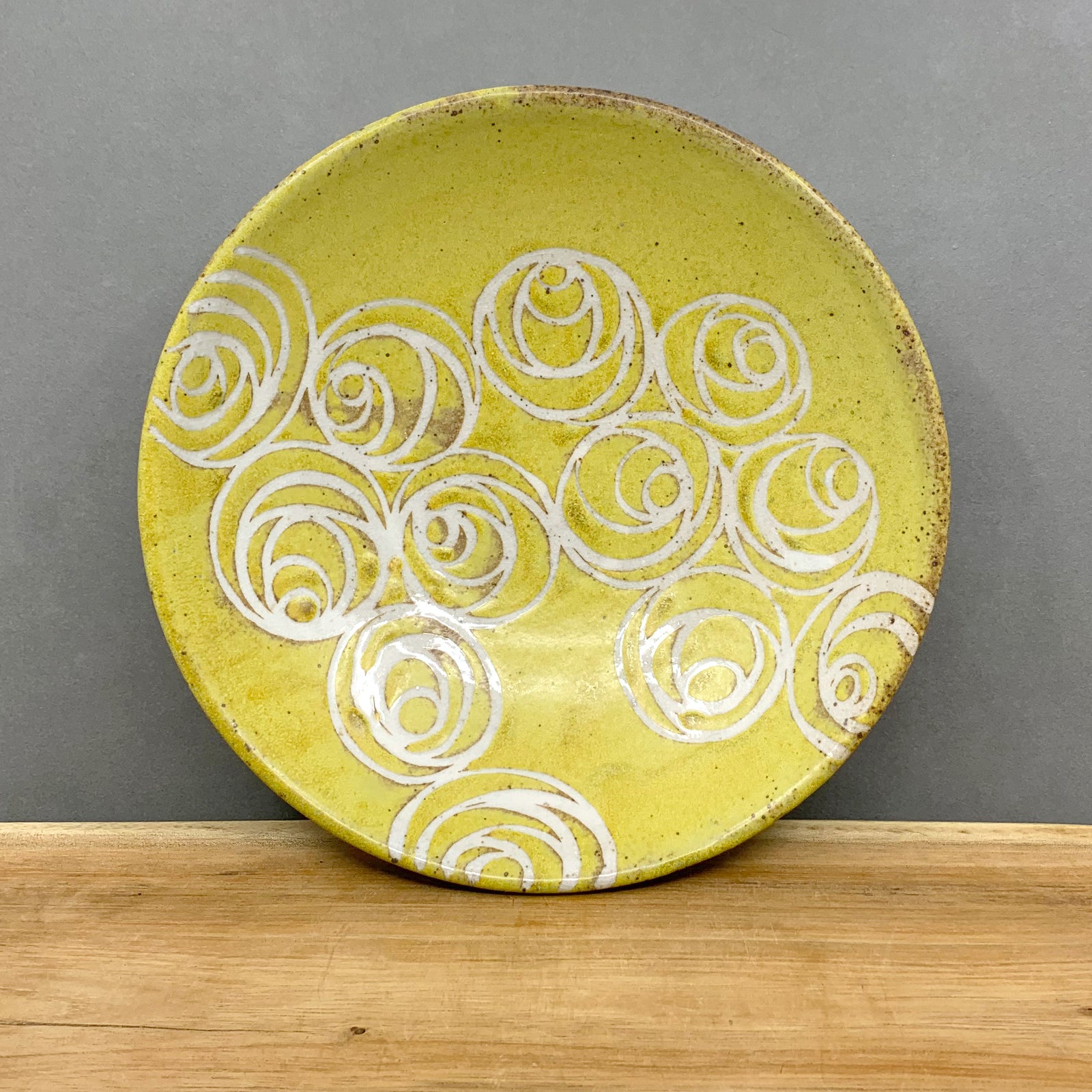Handmade stoneware pasta bowl with yellow glaze and white rosette pattern by Western NC potter Julie Covington. Available at larkandkey.com, Charlotte NC.