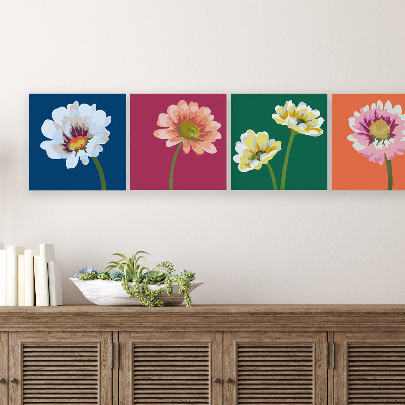 Four 8 inch colorful daisy paintings displayed on a wall, lined up in a row. Artwork by Michele Aschenbrenner for the "Wallflowers" exhibit at Lark and Key.