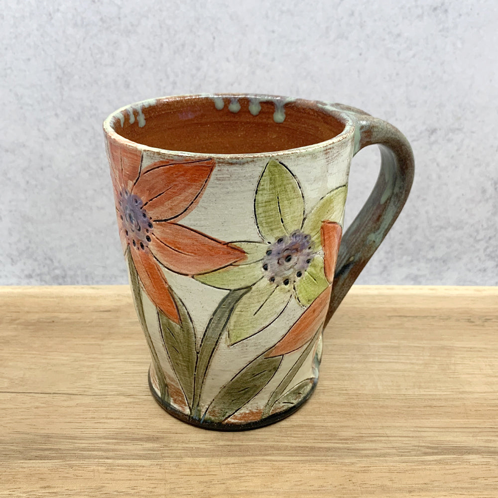 Handmade ceramic mug with flower decoration by Molly Lithgo. Made in North Carolina.