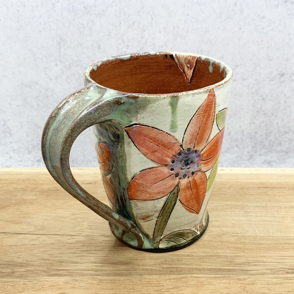 Handmade ceramic mug with flower decoration by Molly Lithgo. Made in North Carolina.
