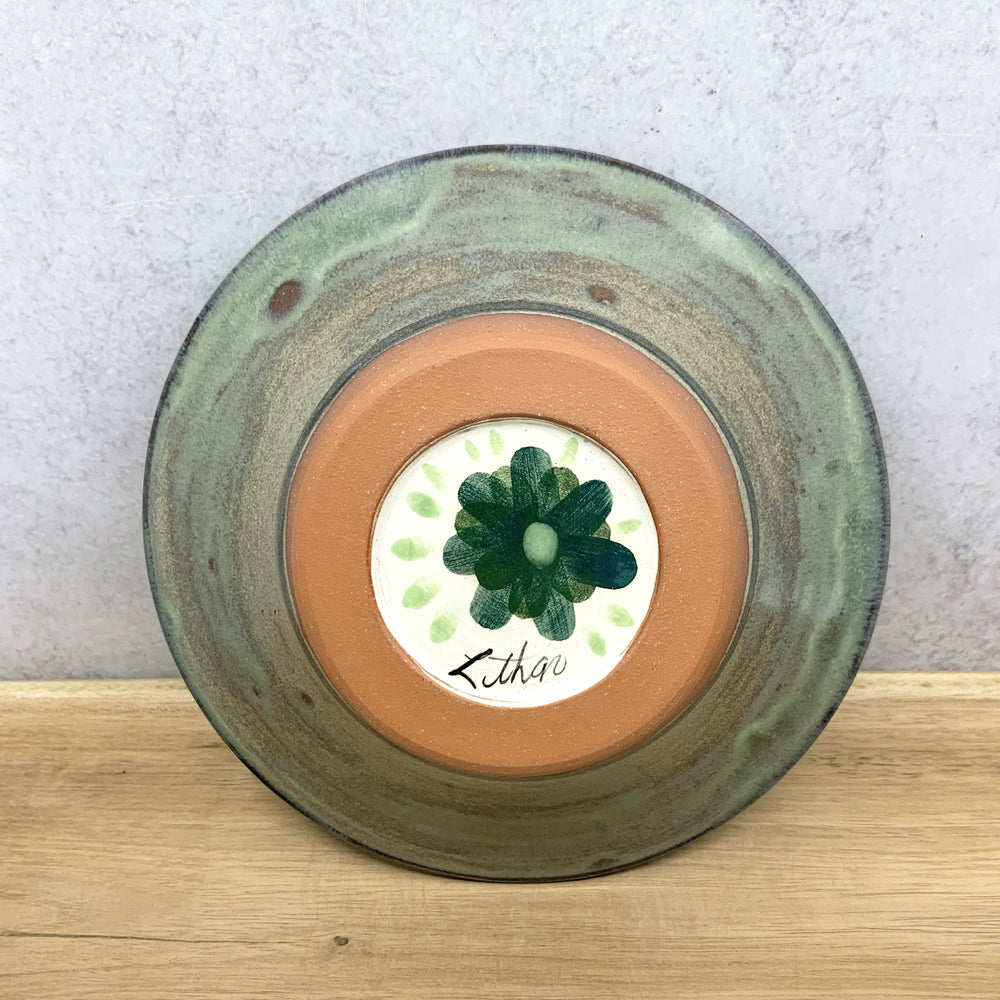 Handmade ceramic bowl with interior flower decoration by Molly Lithgo. Made in North Carolina.