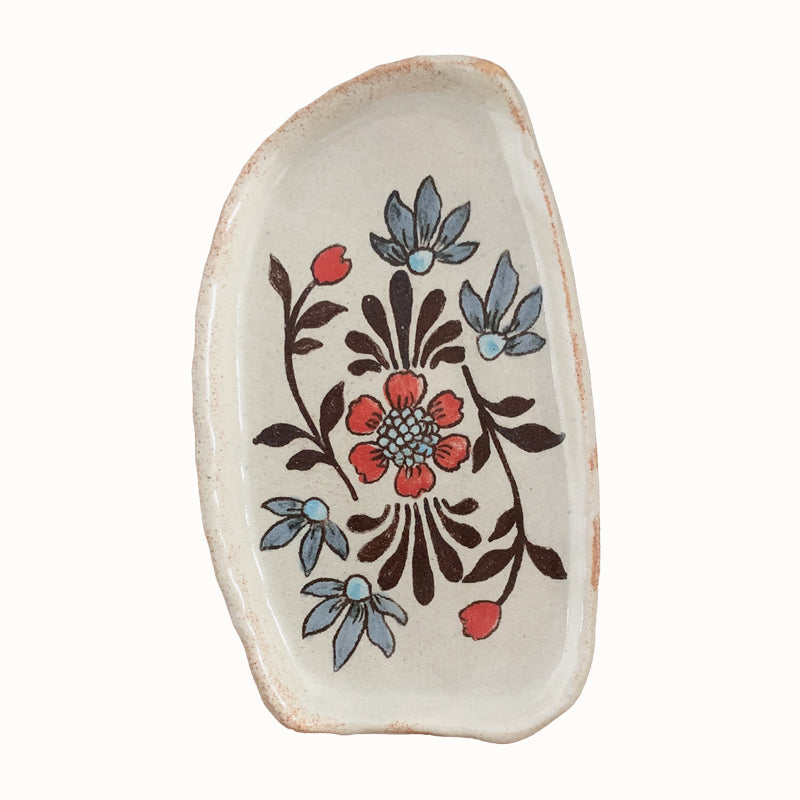 Handmade pottery from Off Menu Pots. Small dish decorated with flower and blue flowers.
