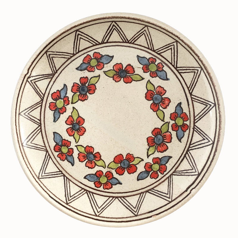 Handmade pottery from Off Menu Pots. Dessert plate with blue, red and chartreuse flowers.