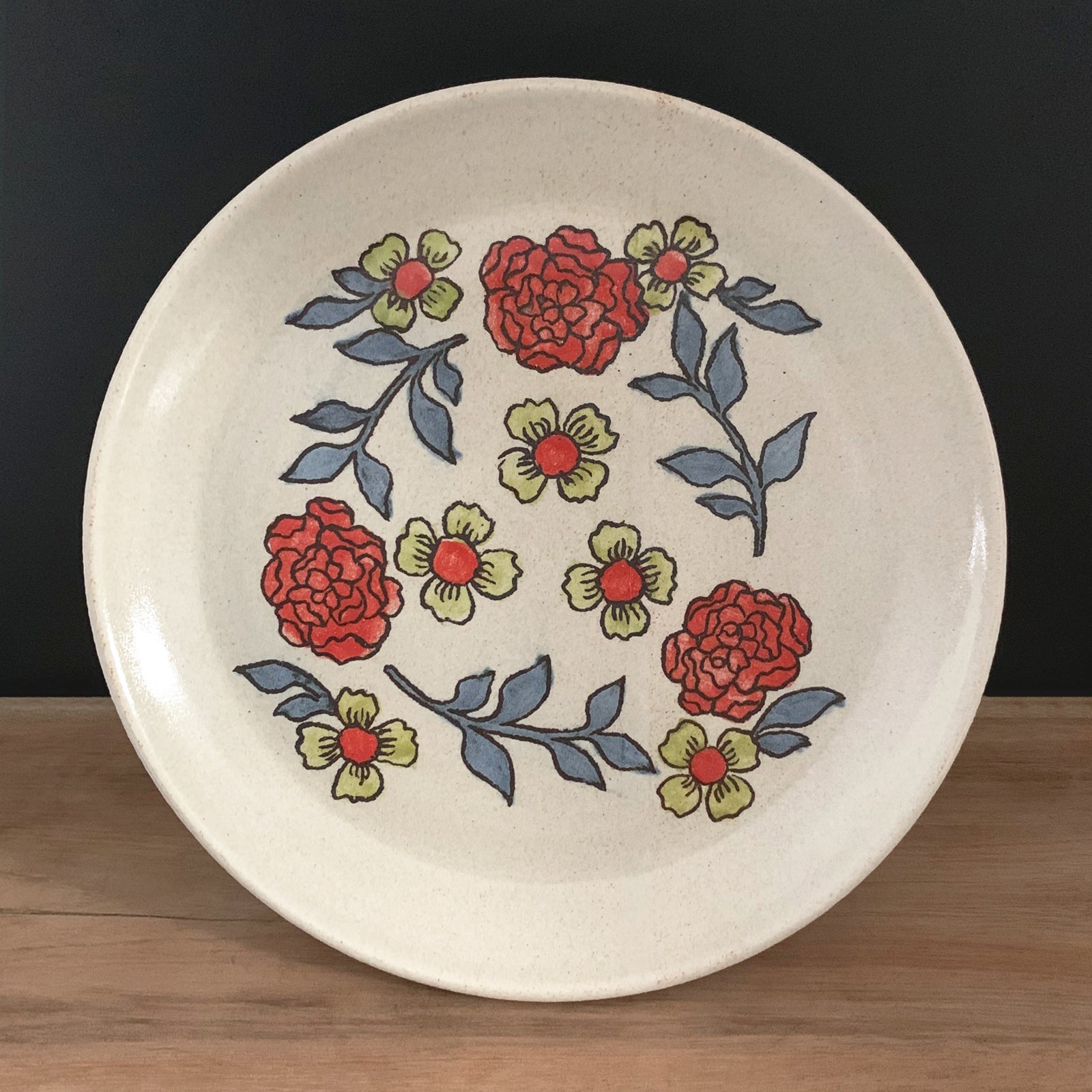 Handmade pottery from Off Menu Pots. Dessert plate with red and charteuse flowers.