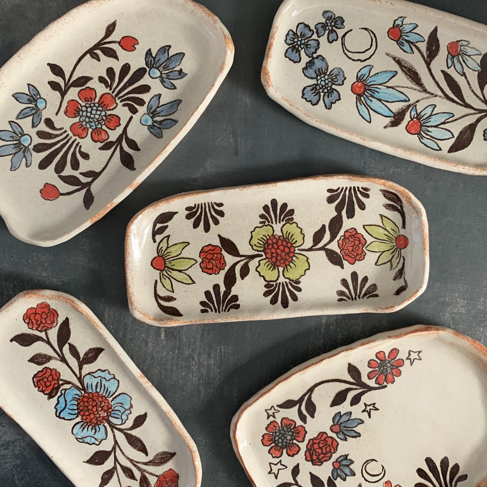 Handmade pottery from Off Menu Pots. Small dishes decorated with flower and moon designs.