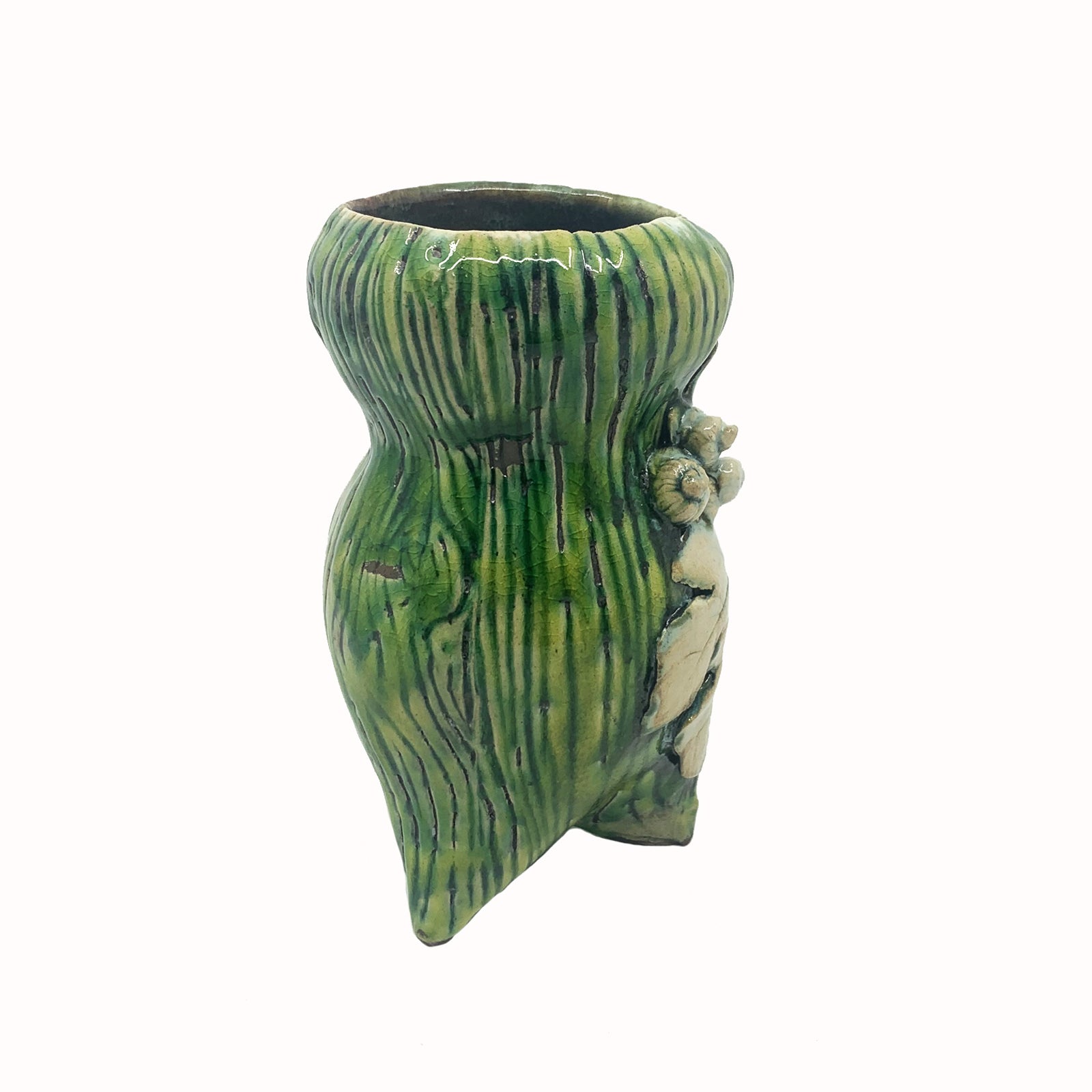 Handmade ceramic vase by artist Paula Smith. Curvy vase, green body with woodgrain detail, decorated with white fig leaves. Side view.