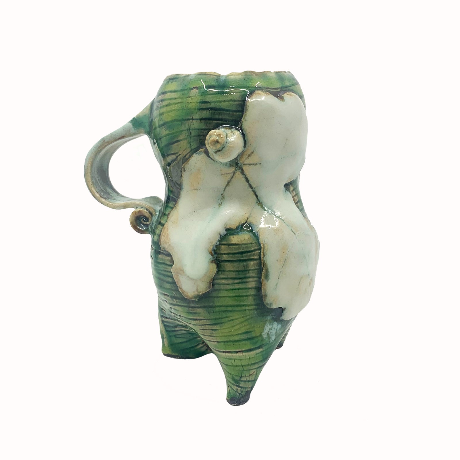 Handmade ceramic cup by artist Paula Smith. Curvy cup with handle, green body with woodgrain detail, decorated with white fig leaf and white flowers on reverse side.
