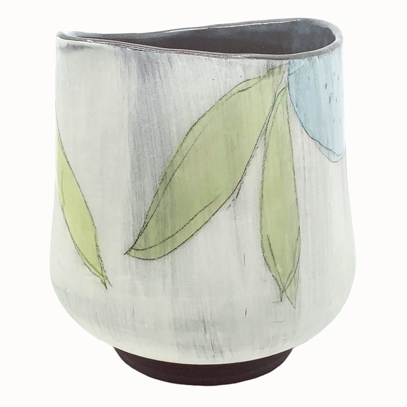 Large oval flower vase by ceramic artist Robin Ralston Frelier. White with dark brown base and interior, and large graphic flower decoration in blue, pink and green. Angled view.