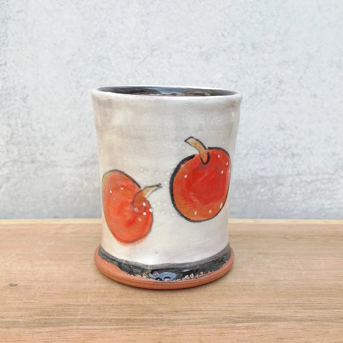 Handmade ceramic cup by NC potter Molly Lithgo. White with apple  decoration. 