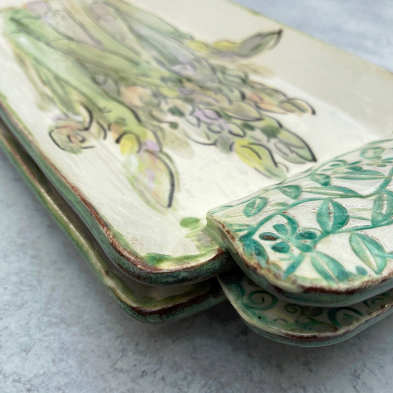 Handmade ceramic serving tray by Molly Lithgo, with asparagus. Detail with handle.