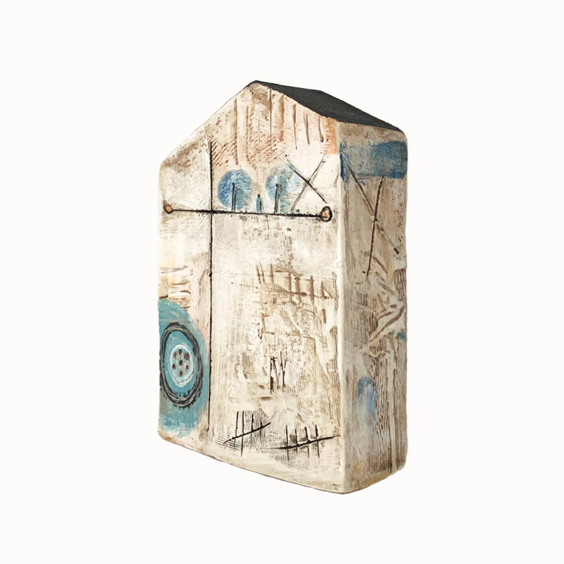Handmade ceramic house by artist Barbara Chadwick, textured with blue circle details. View 2 