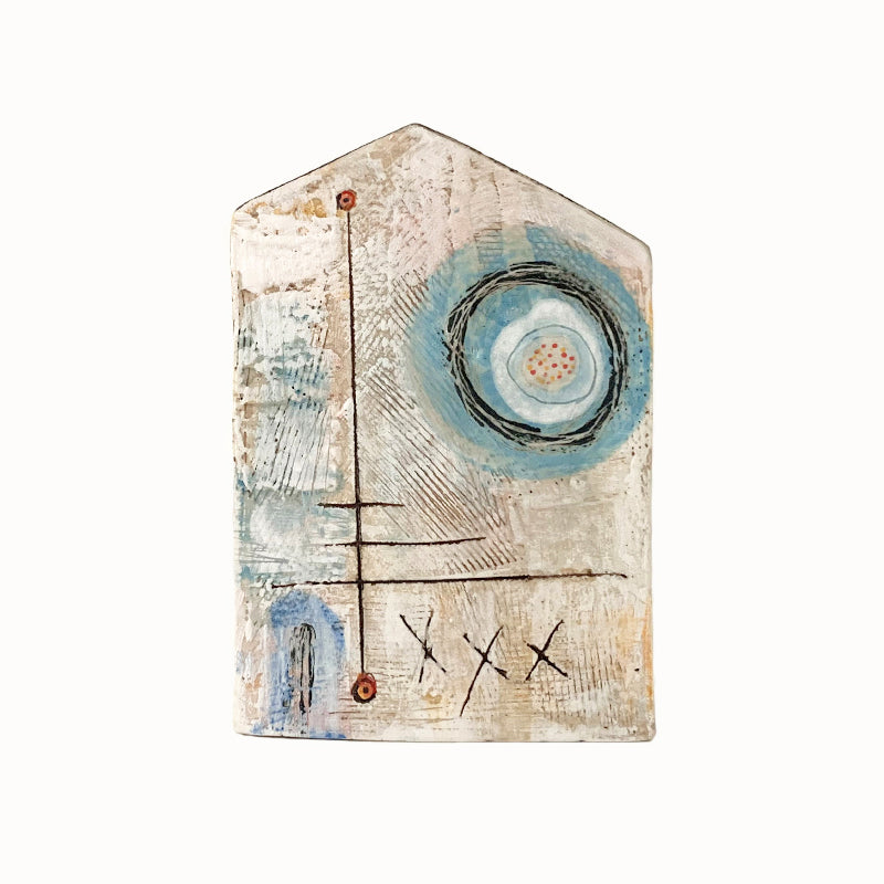 Handmade ceramic house by artist Barbara Chadwick, textured with blue circle details.