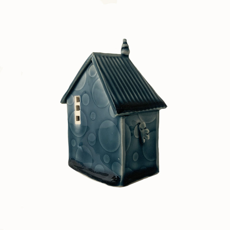 Handmade porcelain house by ceramic artist Barbara Chadwick, blue with dot details. Back view.