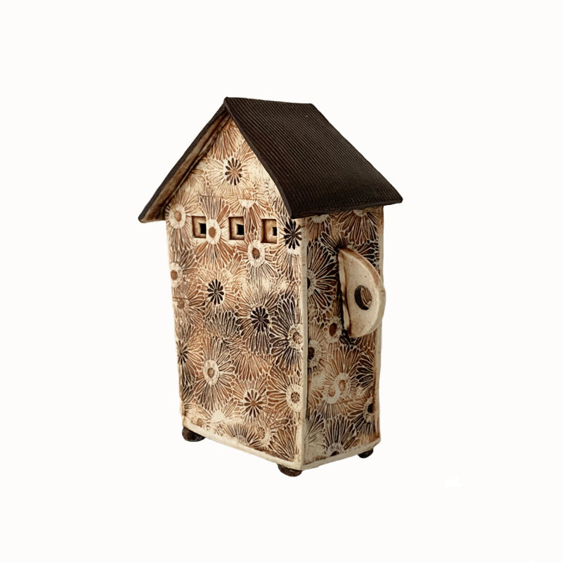 Handmade porcelain house by ceramic artist Barbara Chadwick, daisy pattern in cream, orange and brown. Back view.