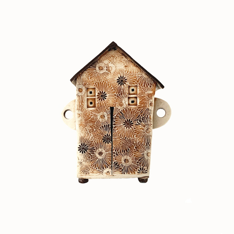 Handmade porcelain house by ceramic artist Barbara Chadwick, daisy pattern in cream, orange and brown.