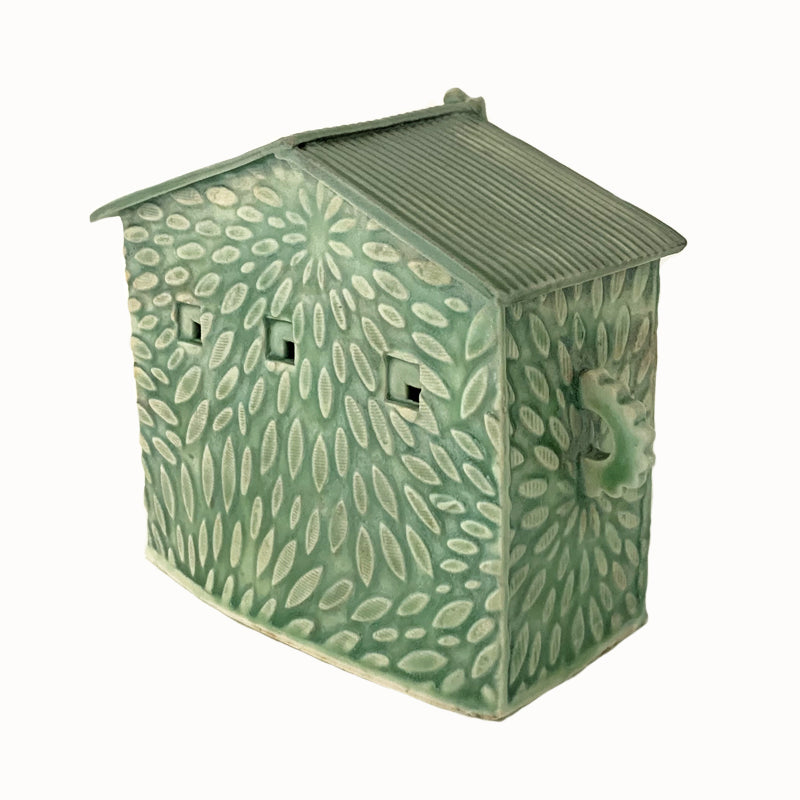 Handmade ceramic house by artist Barbara Chadwick, green with flower petals texture. Back view.