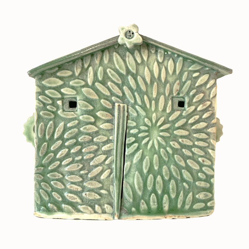 Handmade ceramic house by artist Barbara Chadwick, green with flower petals texture.
