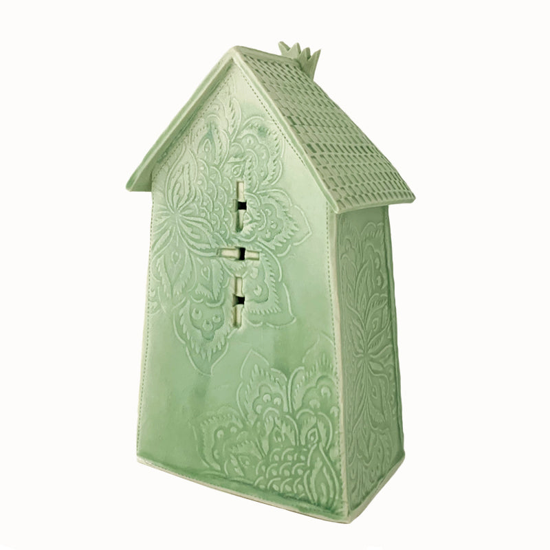 Handmade ceramic house by artist Barbara Chadwick, lt green with mandala flower details. Back view.