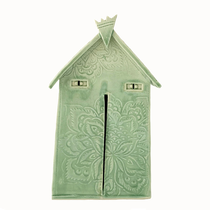 Handmade ceramic house by artist Barbara Chadwick, lt green with mandala flower details.