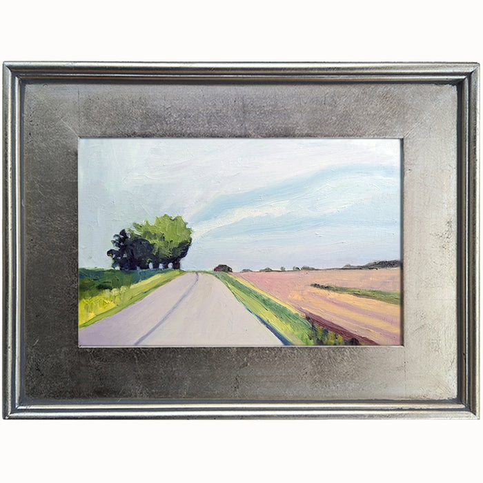 "On the Open Road" oil painting by Bridgette Guerzon Mills. Small landscape painting with pale blue sky, pink fields and trees, set in a silver frame.