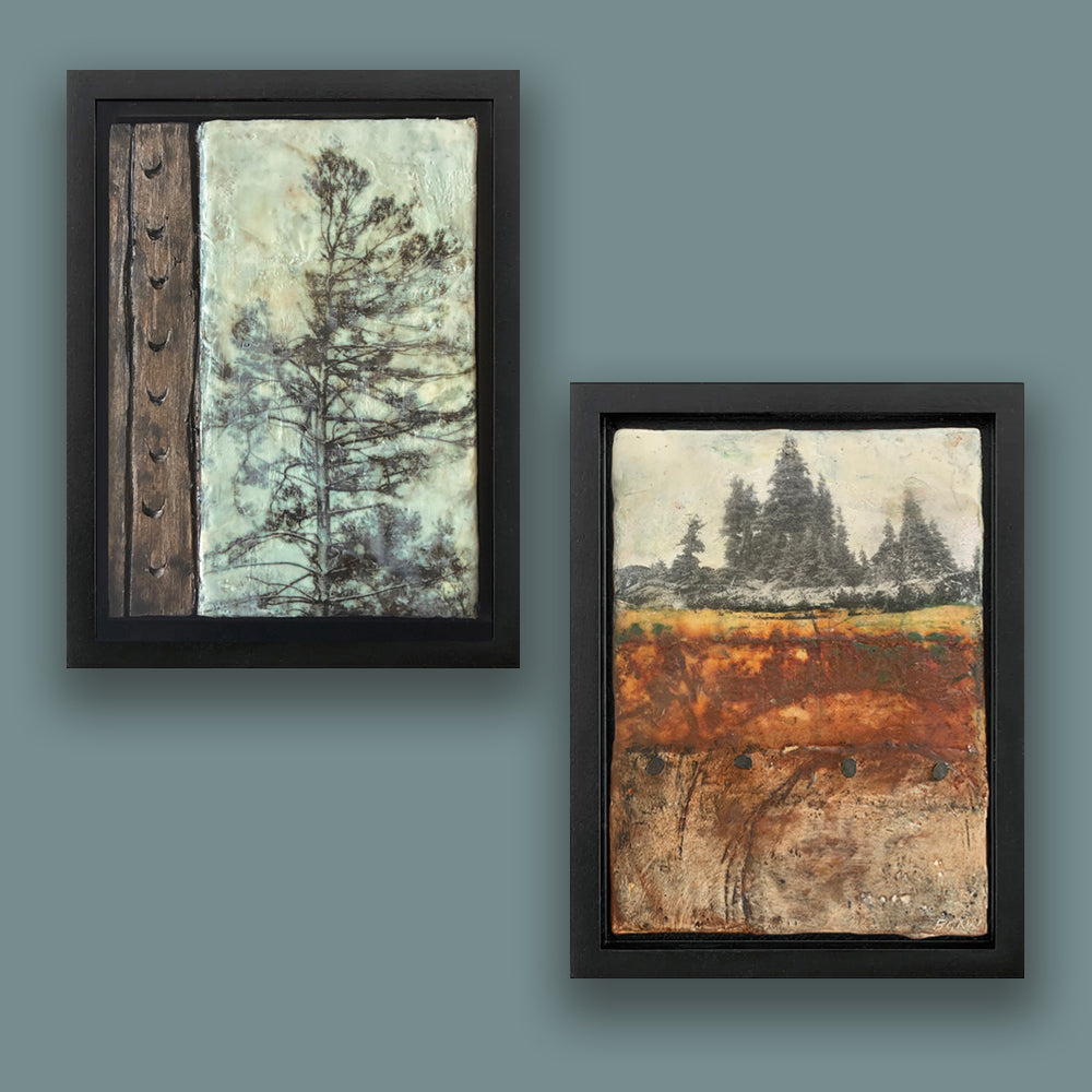 Two framed artworks on a blue wall, depicting tree imagery. Paintings hung on blue wall.