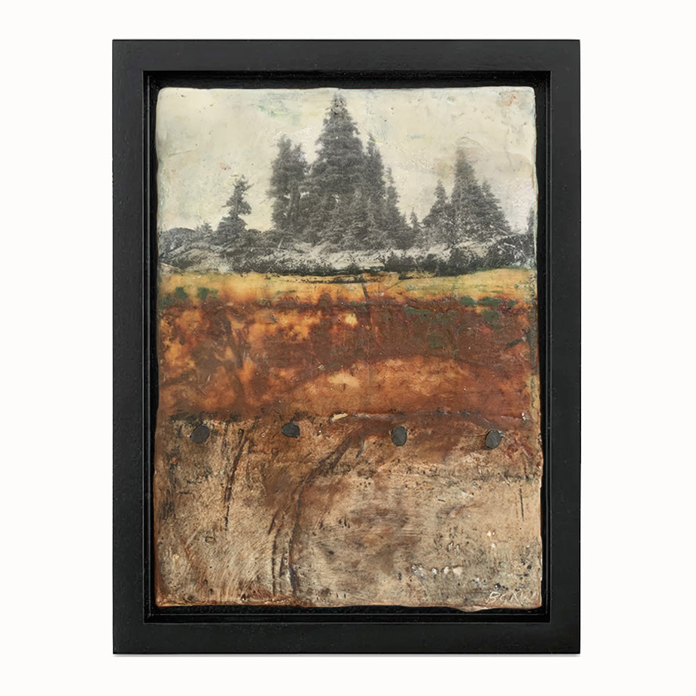 Small mixed media landscape with trees in rustic colors and with nail head details. Set in black frame.