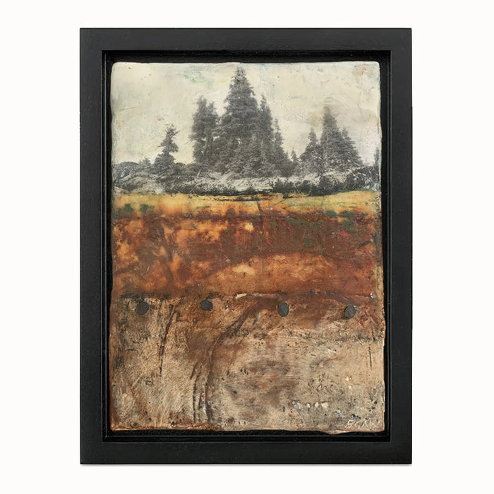 Small mixed media landscape with trees in rustic colors and with nail head details. Set in black frame.